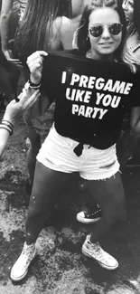 Monochrome party scene with stylish crowd and bold slogan on t-shirt.