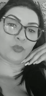 Monochrome portrait of a woman with glasses.