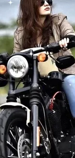 Woman in sunglasses riding a motorcycle on the road with a stylish look.