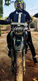 A stylish motorcycle rider on a dirt road, ready for an adventure.