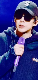 Stylish musician with sunglasses and a purple microphone.