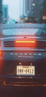 Sleek Porsche 911 Carrera in urban night rain.