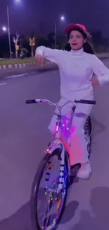 A stylish woman cycling on a neon-lit street at night.