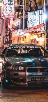 Nissan Skyline GT-R amidst vibrant Japanese city lights at night.