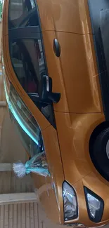 Stylish orange car parked in a wooden sheltered area.