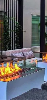 Outdoor lounge with fire tables and seating area featuring greenery.