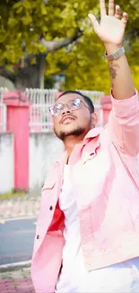 Fashionable person outdoors in stylish pink attire.