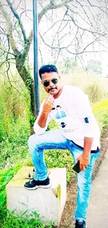 Stylish pose in nature with bright green backdrop.