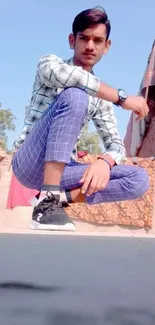 Young man in street fashion posing outside.