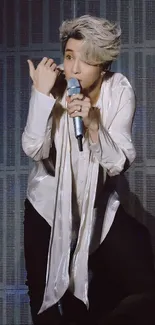 Stylish performer on stage with microphone.