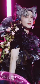 Performer with floral and ruffled outfit in black.