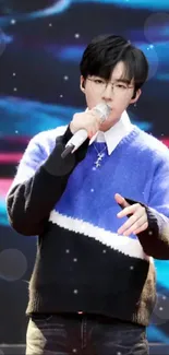 Performer in blue sweater mobile wallpaper.