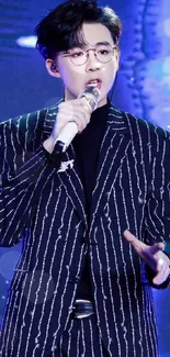 Performer in striped suit on blue stage