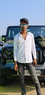 Man in sunglasses with black SUV in background, showcasing urban style.