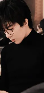 A stylish person in a black turtleneck looking down thoughtfully.