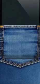 Mobile phone tucked in denim pocket wallpaper.