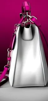 Side view of a pink and white handbag on a magenta background.