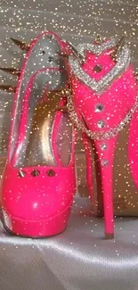 Bright pink high heels with spikes and chain detail.