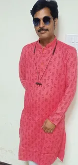 Person wearing a stylish pink kurta with white pants