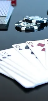 Poker cards and chips on black surface wallpaper.