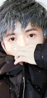 A stylish young person with blue-gray hair in a black jacket.