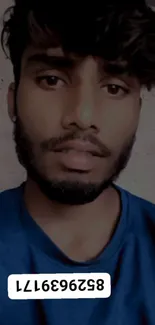 Stylish young man in blue shirt with beard.