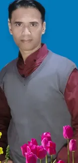 Man in red shirt with floral design on blue background.