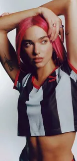 Stylish person with pink hair in a sporty striped top.