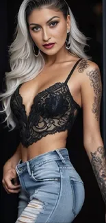 Stylish woman in a black lace top with tattoos and ripped jeans.