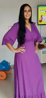 Woman in purple dress in a modern room with decor.