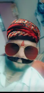 Man with vibrant Rajasthani turban and sunglasses.