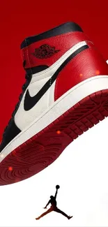 Red and black high-top sneaker wallpaper with a dynamic background.