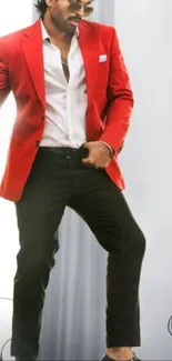 Man in red blazer with stylish pose.