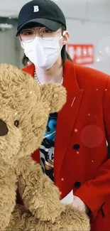 Person in a red coat holding a teddy bear, ideal for wallpaper.