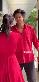 Stylish couple in matching red outfits.