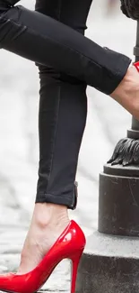 Red high heels and black pants in stylish street fashion.