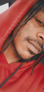 Person wearing a red hoodie in close-up portrait.