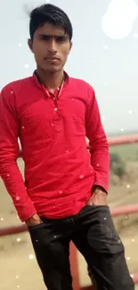 Young man in red shirt with scenic background.