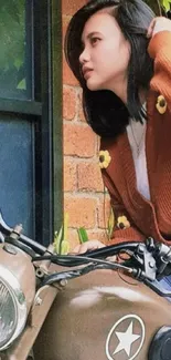 Retro motorcycle with stylish woman against brick wall.