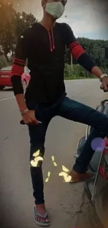 Masked young man posing stylishly by a road with a vehicle.