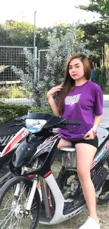 A woman in a purple top sitting on a stylish scooter outdoors.