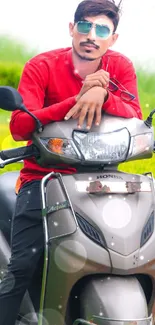 Young man in red shirt on scooter with green background.