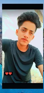 Stylish young man taking a selfie by the beach with a stunning coastal view.