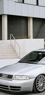 Sleek silver car set against a modern urban background.