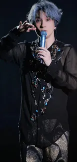 Singer in black outfit performing on stage.