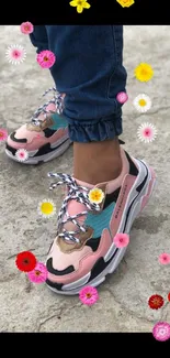 Stylish pink and teal sneakers on concrete surface.