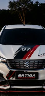 Front view of a sports car with black and red graphics on a sleek design background.