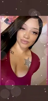 Woman with star tattoo in burgundy top.