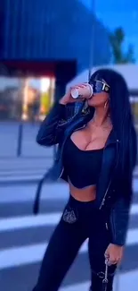 Woman in stylish black outfit drinking coffee, urban background.