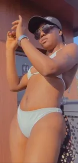 Woman in beachwear enjoying sunny outdoor setting.